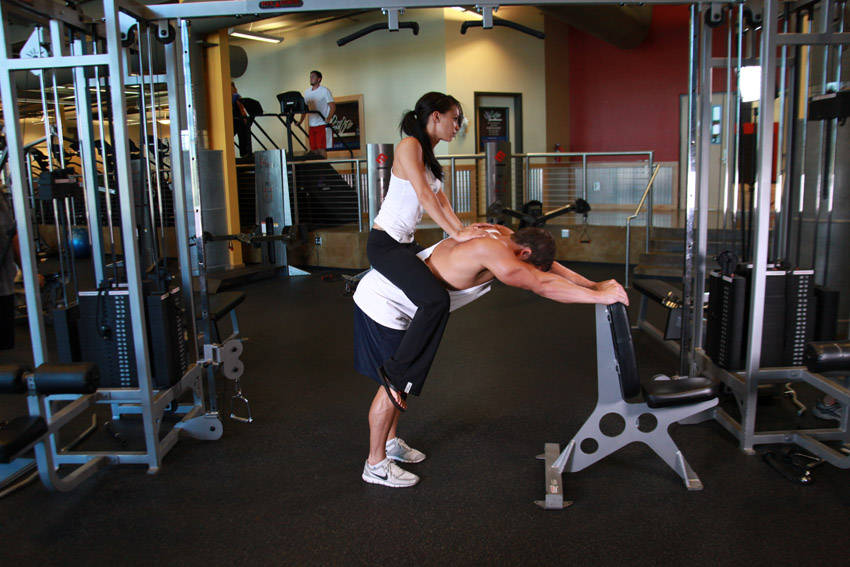 Demonstration of Donkey Calf Raises exercise showing proper form and technique