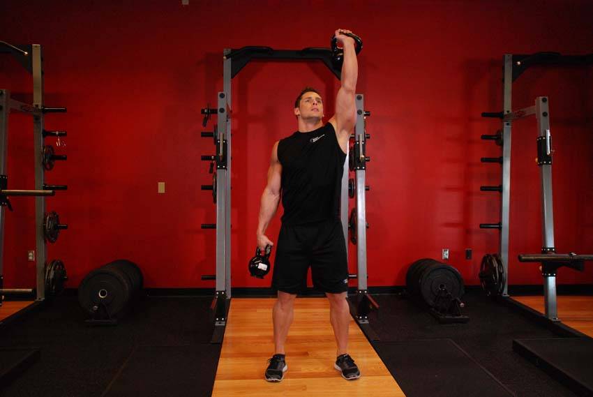 Demonstration of Double Kettlebell Windmill exercise showing proper form and technique