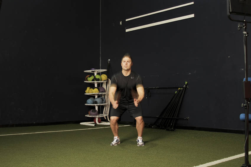 Demonstration of Double Leg Butt Kick exercise showing proper form and technique