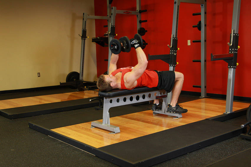 Demonstration of Dumbbell Flyes exercise showing proper form and technique