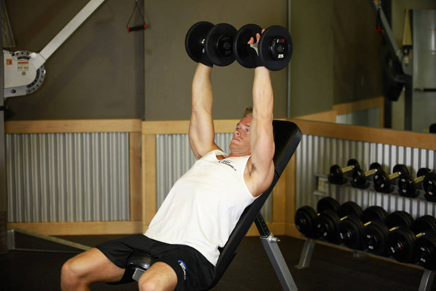 Demonstration of Dumbbell Incline Shoulder Raise exercise showing proper form and technique
