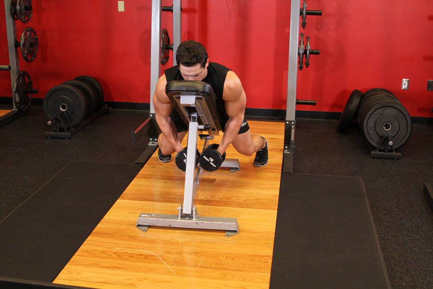 Demonstration of Dumbbell Lying Rear Lateral Raise exercise showing proper form and technique