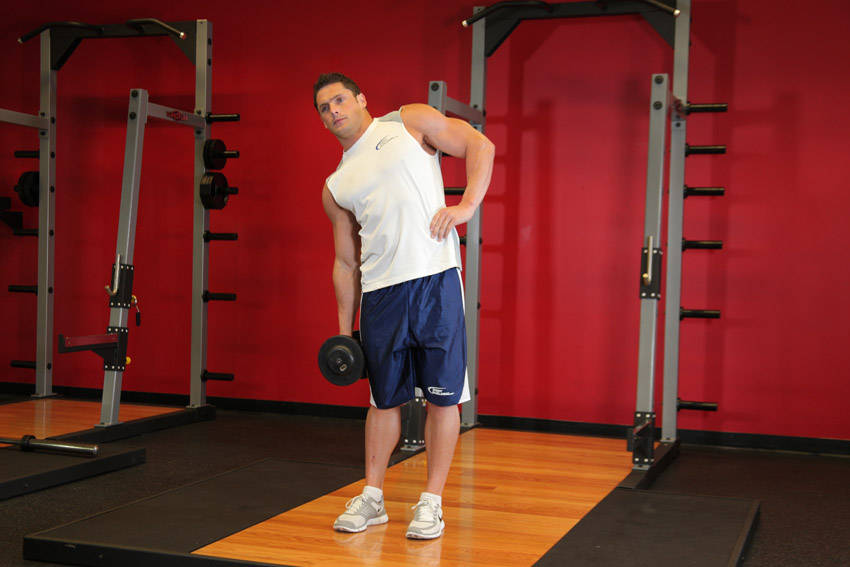 Demonstration of Dumbbell Side Bend exercise showing proper form and technique