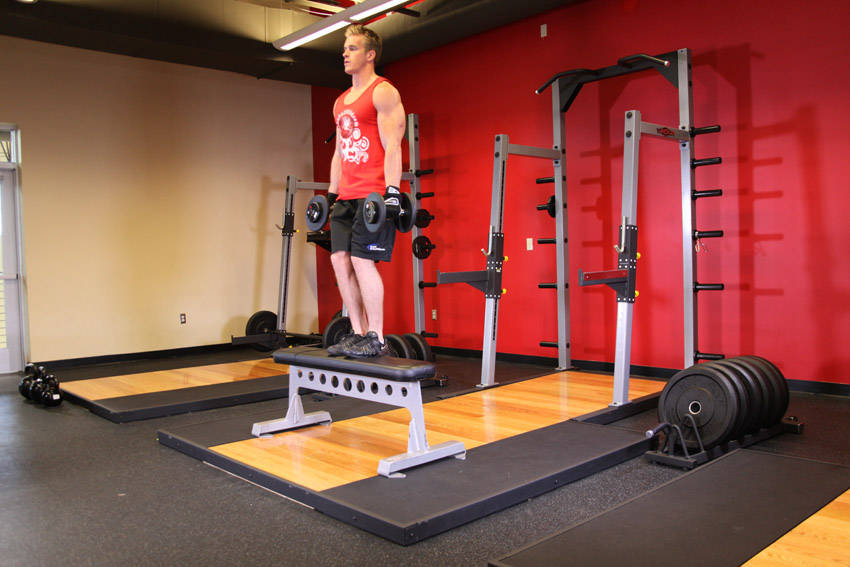 Demonstration of Dumbbell Step Ups exercise showing proper form and technique