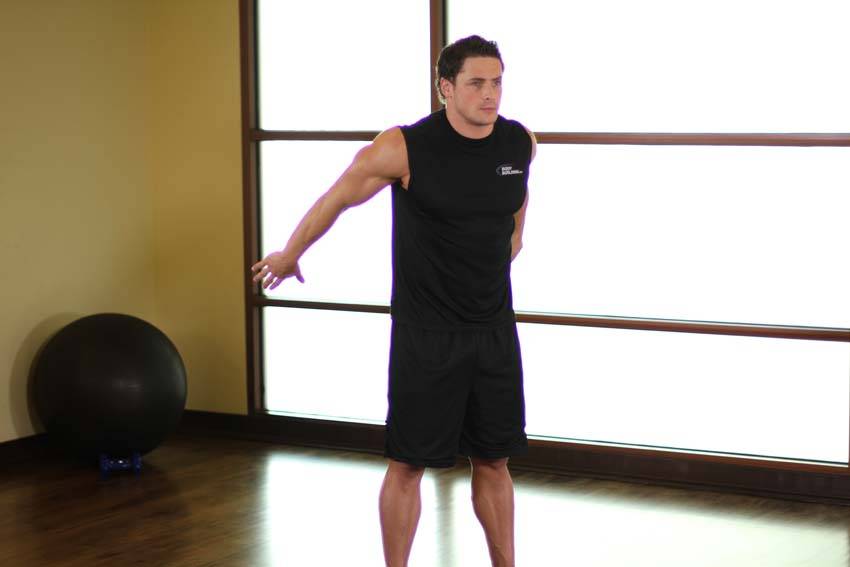 Demonstration of Dynamic Back Stretch exercise showing proper form and technique
