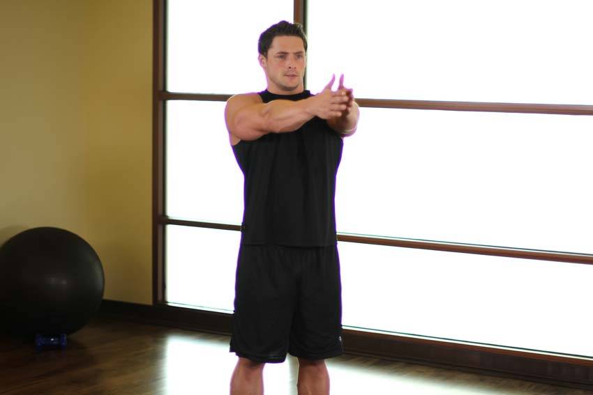 Demonstration of Dynamic Chest Stretch exercise showing proper form and technique