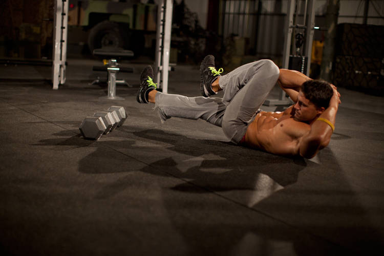 Demonstration of Elbow to Knee exercise showing proper form and technique