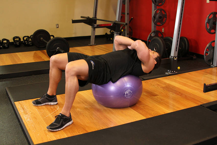 Demonstration of Exercise Ball Crunch exercise showing proper form and technique