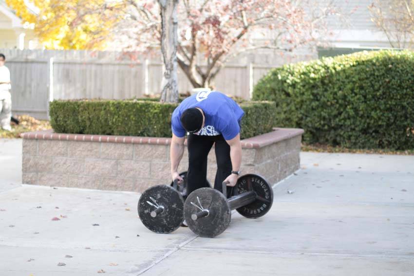 Demonstration of Farmer's Walk exercise showing proper form and technique