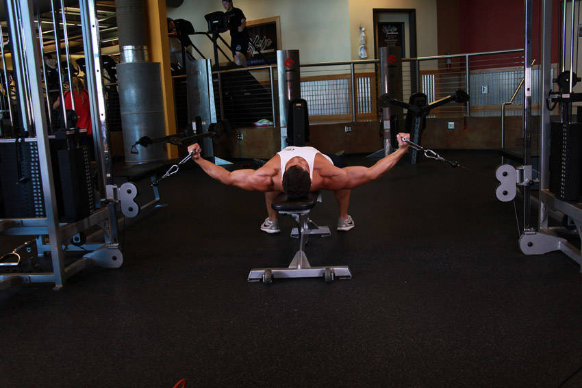 Demonstration of Flat Bench Cable Flyes exercise showing proper form and technique