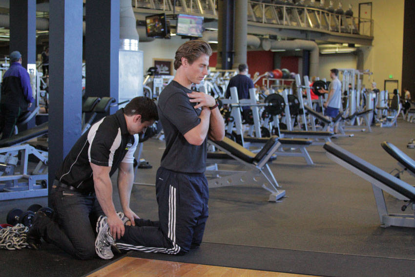 Demonstration of Floor Glute-Ham Raise exercise showing proper form and technique