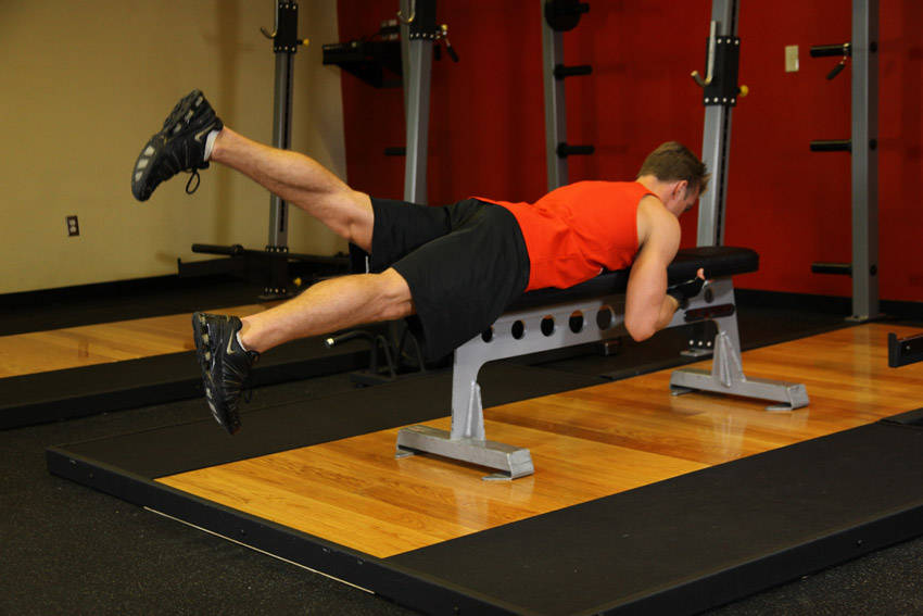 Demonstration of Flutter Kicks exercise showing proper form and technique