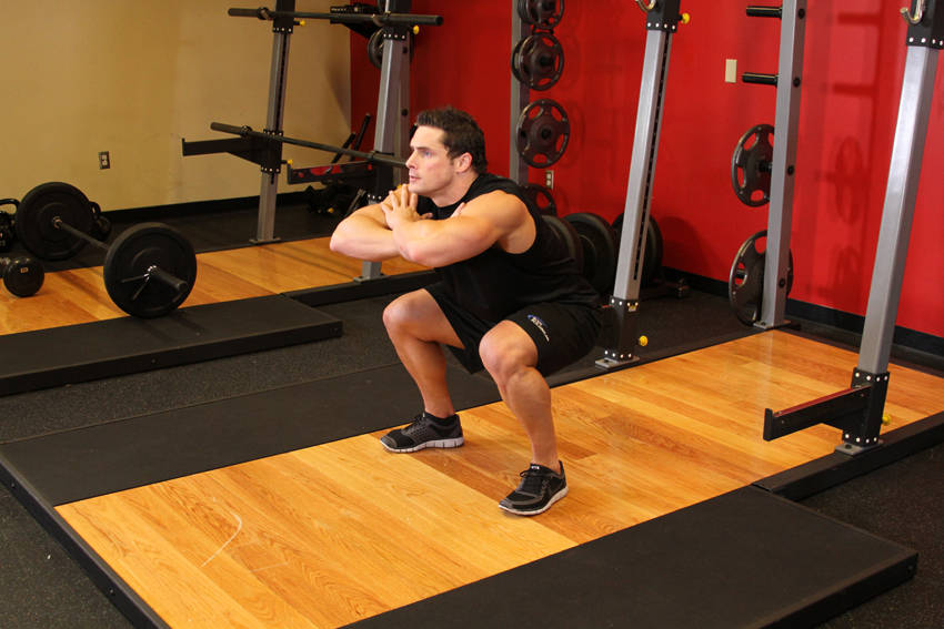 Demonstration of Freehand Jump Squat exercise showing proper form and technique