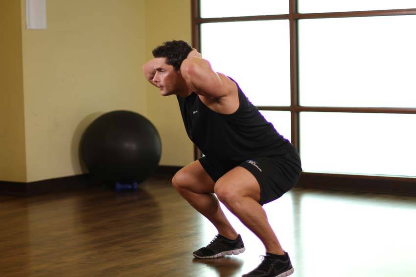 Demonstration of Frog Hops exercise showing proper form and technique
