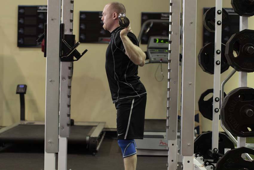Demonstration of Good Morning exercise showing proper form and technique