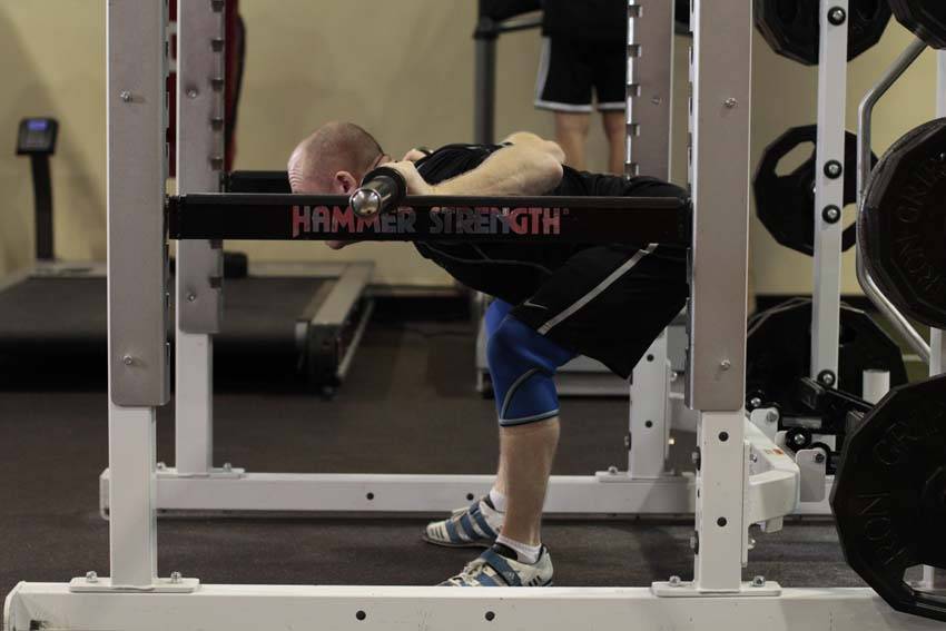 Demonstration of Good Morning off Pins exercise showing proper form and technique