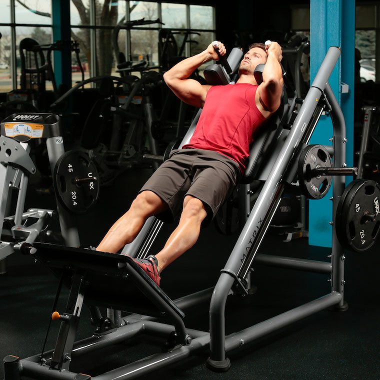 Demonstration of Hack Squat exercise showing proper form and technique