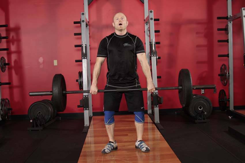 Demonstration of Hang Clean exercise showing proper form and technique