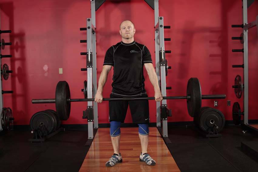 Demonstration of Hang Clean - Below the Knees exercise showing proper form and technique
