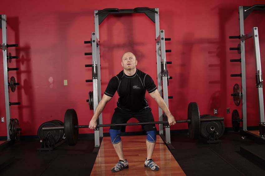 Demonstration of Hang Snatch exercise showing proper form and technique