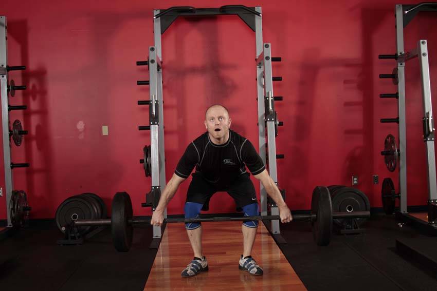 Demonstration of Hang Snatch - Below Knees exercise showing proper form and technique