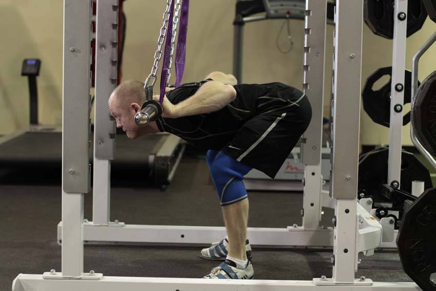 Demonstration of Hanging Bar Good Morning exercise showing proper form and technique
