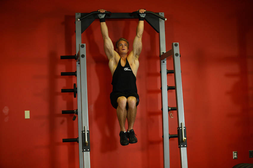 Demonstration of Hanging Pike exercise showing proper form and technique