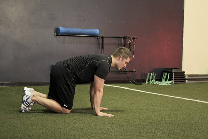 Demonstration of Hip Circles (prone) exercise showing proper form and technique