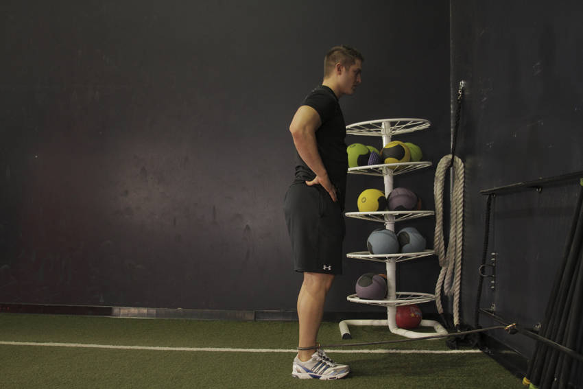 Demonstration of Hip Extension with Bands exercise showing proper form and technique