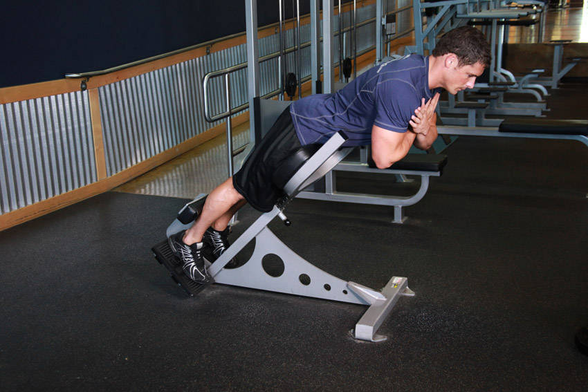 Demonstration of Hyperextensions (Back Extensions) exercise showing proper form and technique