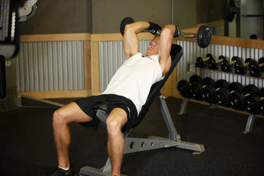Demonstration of Incline Barbell Triceps Extension exercise showing proper form and technique