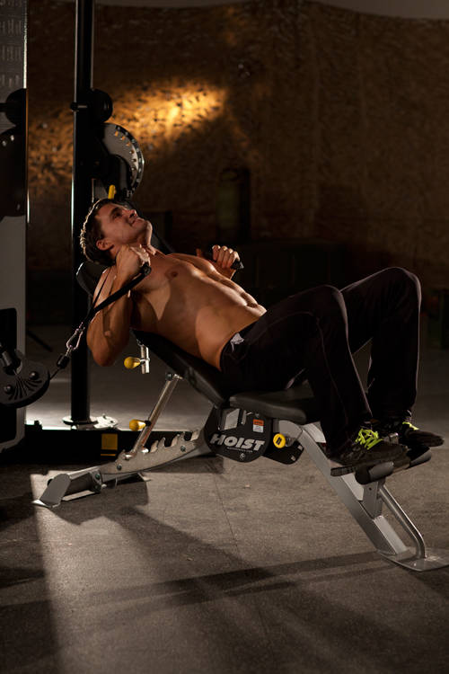 Demonstration of Incline Cable Chest Press exercise showing proper form and technique