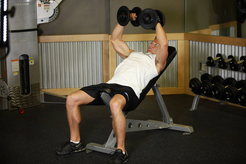 Demonstration of Incline Dumbbell Flyes exercise showing proper form and technique