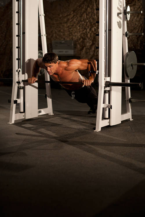 Demonstration of Incline Push-Up Wide exercise showing proper form and technique