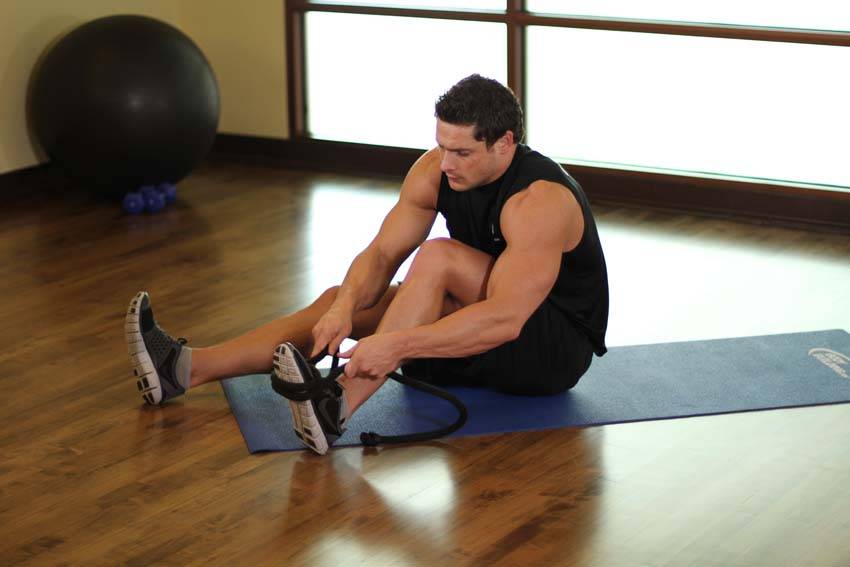 Demonstration of Intermediate Groin Stretch exercise showing proper form and technique