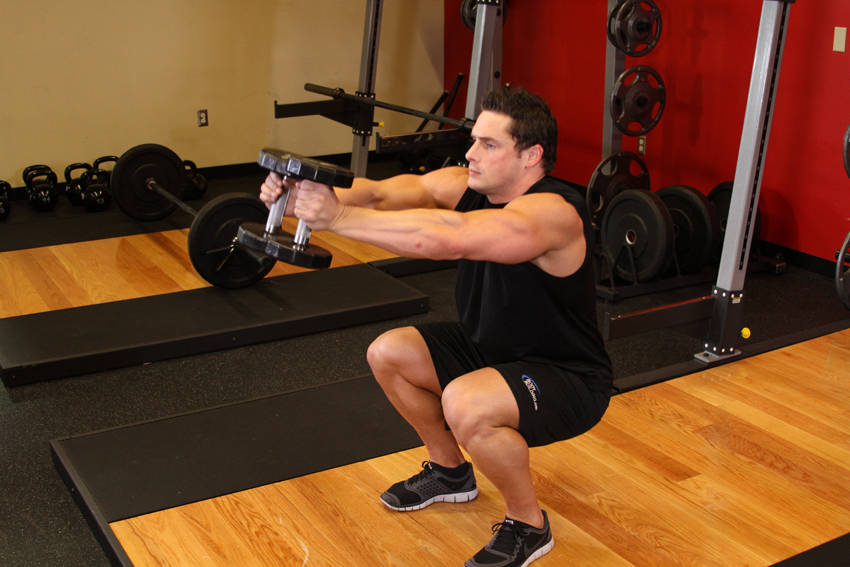 Demonstration of Iron Cross exercise showing proper form and technique