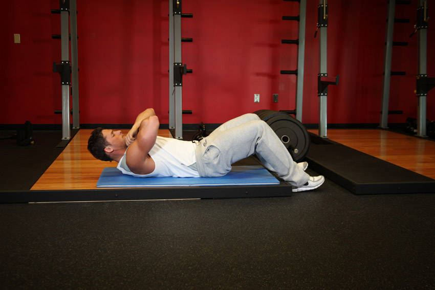 Demonstration of Janda Sit-Up exercise showing proper form and technique