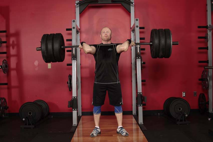 Demonstration of Jerk Dip Squat exercise showing proper form and technique