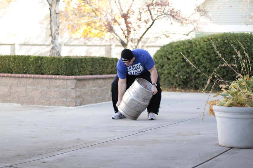 Demonstration of Keg Load exercise showing proper form and technique