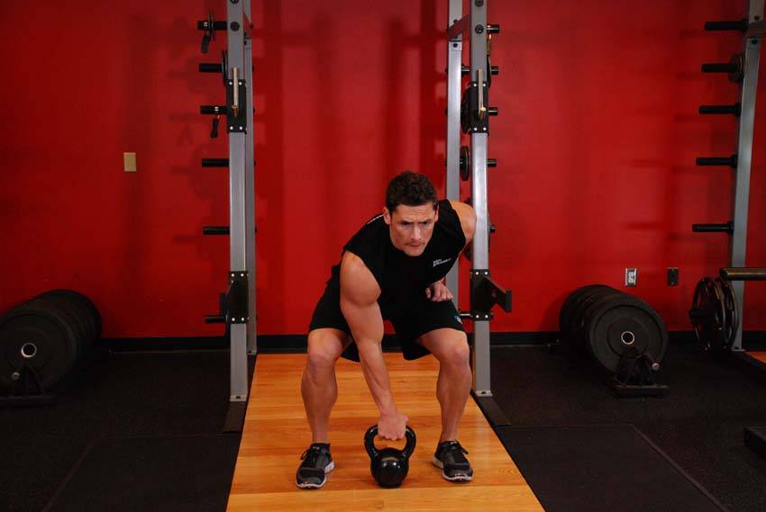Demonstration of Kettlebell Dead Clean exercise showing proper form and technique