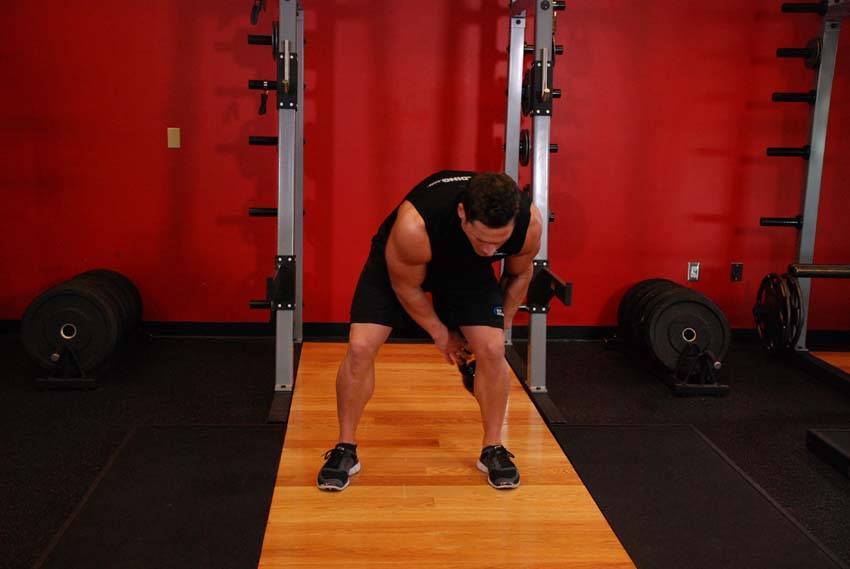 Demonstration of Kettlebell Figure 8 exercise showing proper form and technique