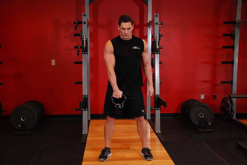 Demonstration of Kettlebell Hang Clean exercise showing proper form and technique