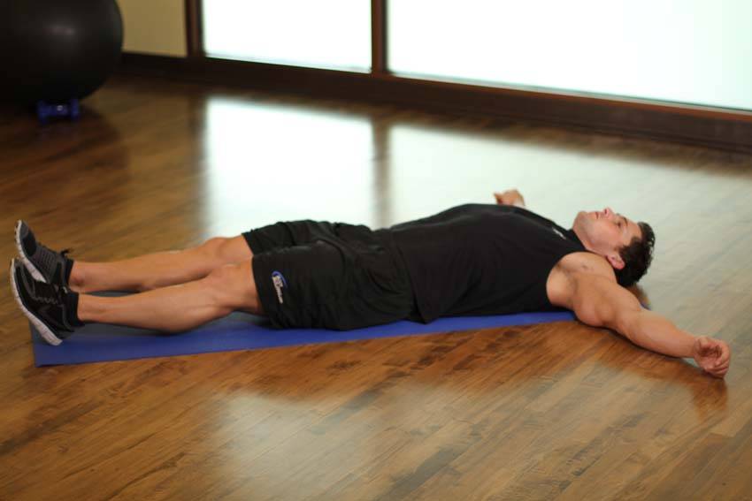 Demonstration of Knee Across The Body exercise showing proper form and technique