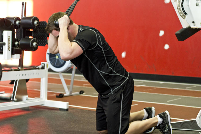 Demonstration of Kneeling Cable Crunch With Alternating Oblique Twists exercise showing proper form and technique