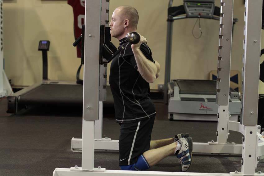 Demonstration of Kneeling Squat exercise showing proper form and technique