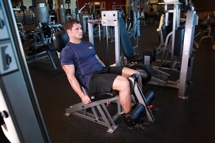 Demonstration of Leg Extensions exercise showing proper form and technique