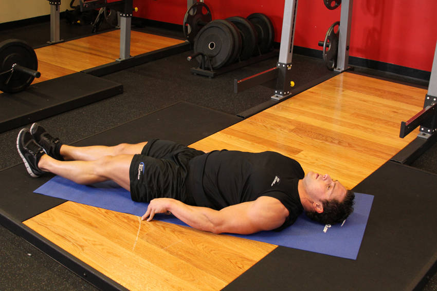 Demonstration of Leg Pull-In exercise showing proper form and technique