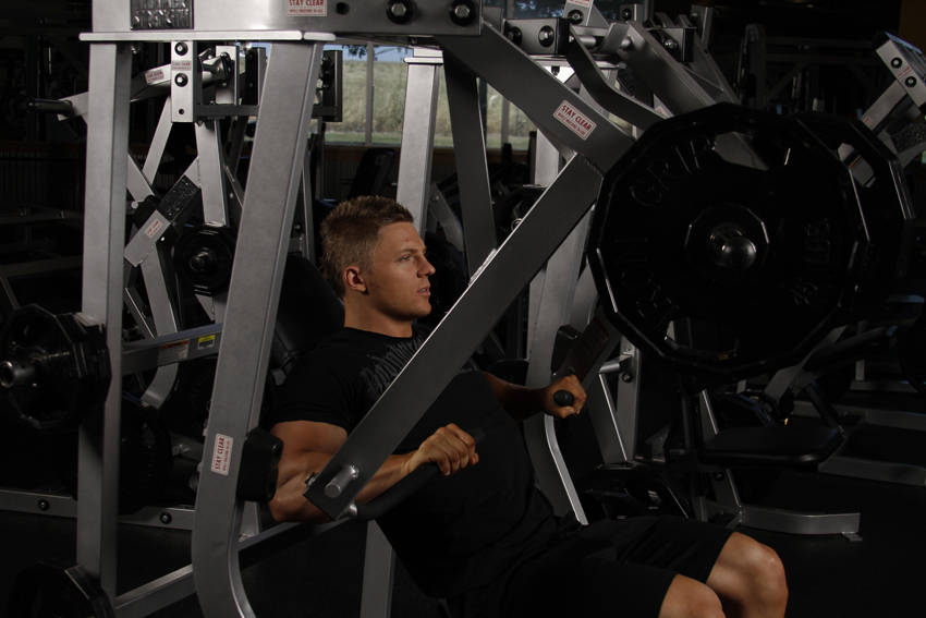 Demonstration of Leverage Decline Chest Press exercise showing proper form and technique