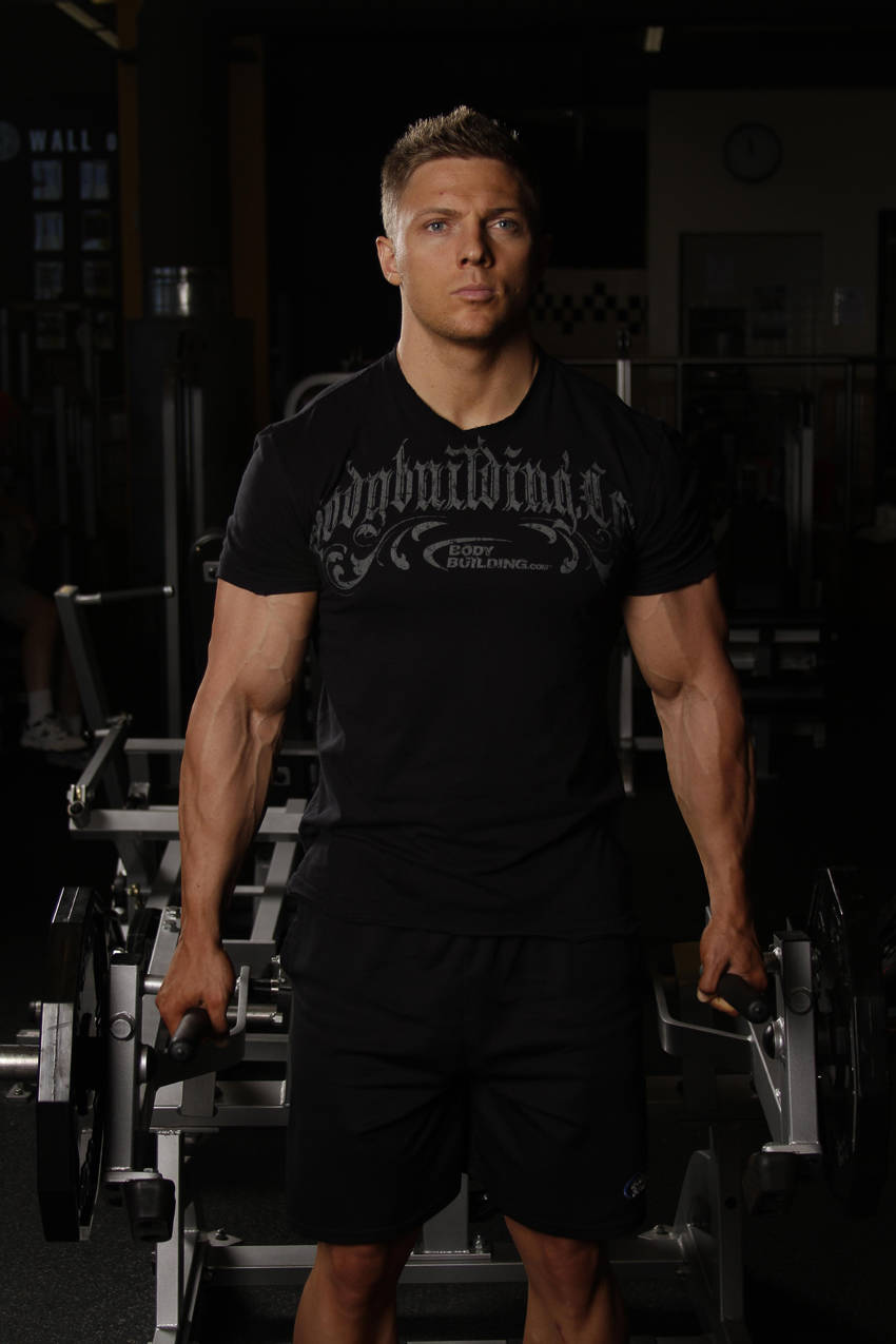 Demonstration of Leverage Shrug exercise showing proper form and technique