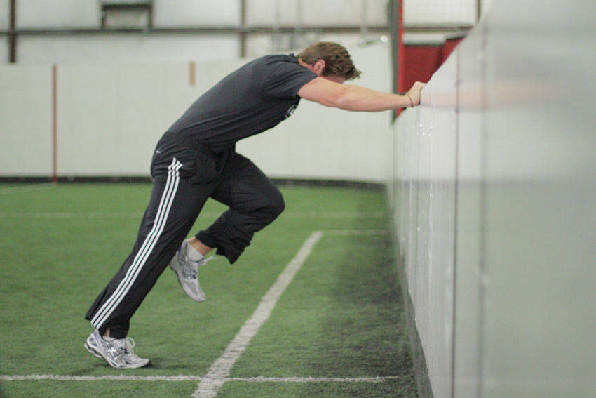 Demonstration of Linear Acceleration Wall Drill exercise showing proper form and technique